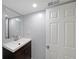 Bathroom featuring a modern sink, cabinet, and a well-lit mirror above the vanity at 6835 Castleton Dr, Sandy Springs, GA 30328