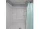 Bright bathroom featuring a standing shower with integrated shelves and curtain at 6835 Castleton Dr, Sandy Springs, GA 30328