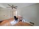 Bright bedroom featuring a ceiling fan, hardwood floors, and ample closet space at 6835 Castleton Dr, Sandy Springs, GA 30328