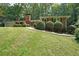 Charming brick home featuring a neat front yard and mature trees, creating a welcoming curb appeal at 6835 Castleton Dr, Sandy Springs, GA 30328