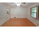Bright living room featuring hardwood floors, ceiling fan, and natural light from the window at 6835 Castleton Dr, Sandy Springs, GA 30328