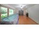 Spacious living room with hardwood floors, large windows, and natural light streaming in at 6835 Castleton Dr, Sandy Springs, GA 30328