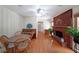 Charming living room with a classic brick fireplace, hardwood floors, and bright natural light at 6835 Castleton Dr, Sandy Springs, GA 30328