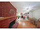 Spacious living area featuring a red brick fireplace that connects seamlessly to an adjacent kitchen at 6835 Castleton Dr, Sandy Springs, GA 30328