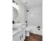 Bathroom featuring a modern vanity, round mirror, and tiled shower for a clean, contemporary look at 1172 Rockmart Nw Cir, Kennesaw, GA 30144