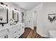 Bright bathroom featuring double vanities, modern fixtures, and a separate shower area at 1172 Rockmart Nw Cir, Kennesaw, GA 30144