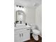 Modern bathroom with a vessel sink, gold-framed mirror, and stylish fixtures, and dark wood floors at 1172 Rockmart Nw Cir, Kennesaw, GA 30144