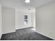 Bright bedroom with neutral walls, gray carpet, and a window that lets in plenty of natural light at 1172 Rockmart Nw Cir, Kennesaw, GA 30144