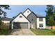 Charming two-story home with gray accents, a spacious two-car garage, and a well-manicured lawn at 1172 Rockmart Nw Cir, Kennesaw, GA 30144
