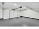 A spacious garage with a white door, gray floor, and automatic door opener at 1172 Rockmart Nw Cir, Kennesaw, GA 30144