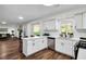 Modern kitchen with stainless appliances, ample counter space, and open layout to the living room at 1172 Rockmart Nw Cir, Kennesaw, GA 30144