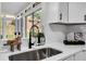 Well-lit kitchen sink features modern faucet and view of backyard at 1172 Rockmart Nw Cir, Kennesaw, GA 30144