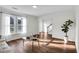 Bright living room with wood flooring, modern furniture, and a large window overlooking the front yard at 1172 Rockmart Nw Cir, Kennesaw, GA 30144
