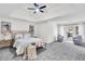 Spacious main bedroom with plush carpeting, a tray ceiling, and a cozy sitting area at 1172 Rockmart Nw Cir, Kennesaw, GA 30144