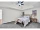 Comfortable main bedroom with plush carpeting, a tray ceiling, and a large bed at 1172 Rockmart Nw Cir, Kennesaw, GA 30144