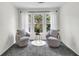 Cozy sitting room with plush chairs, accent pillows, and natural light from the large window at 1172 Rockmart Nw Cir, Kennesaw, GA 30144