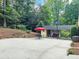 Spacious backyard with a shed, concrete patio, an outdoor dining area, and mature trees at 2151 Desmond Dr, Decatur, GA 30033