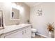 Bathroom with marble countertop vanity, updated fixtures, decorative accents, and tiled floors at 2151 Desmond Dr, Decatur, GA 30033
