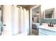 View of a bathroom with a shower curtain, tile accents, a toilet, and an adjacent bedroom view at 2151 Desmond Dr, Decatur, GA 30033