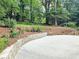 Circular driveway accented with stone retaining wall and manicured landscaping at 2151 Desmond Dr, Decatur, GA 30033