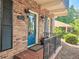 Close-up of the home's entrance showcasing a blue front door, brick facade, and decorative lighting at 2151 Desmond Dr, Decatur, GA 30033