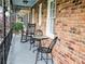 Charming front porch with brick exterior, metal furniture, and decorative railing at 2151 Desmond Dr, Decatur, GA 30033