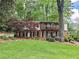 Two-story brick home with large front lawn, mature trees, and manicured landscaping on a sunny day at 2151 Desmond Dr, Decatur, GA 30033