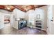 Spacious laundry room with tile floors, storage cabinets, and access to the exterior of the home at 2151 Desmond Dr, Decatur, GA 30033