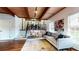 Cozy living room featuring wooden beams, an adjacent dining area, and hardwood floors with area rug at 2151 Desmond Dr, Decatur, GA 30033
