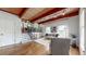 Bright living room features hardwood floors, wooden beam ceiling, stairway, and lots of natural light at 2151 Desmond Dr, Decatur, GA 30033