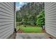 A peaceful backyard with lush greenery viewed from a concrete patio, perfect for relaxation at 2895 Cross Creek Dr, Cumming, GA 30040