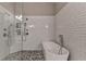 Bathroom with white tiled walls, modern shower, and standalone bathtub at 2895 Cross Creek Dr, Cumming, GA 30040
