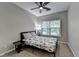 Bedroom with floral print bedspread, ceiling fan, and natural light from a large window at 2895 Cross Creek Dr, Cumming, GA 30040