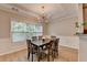 Charming dining room featuring a decorative chandelier, wainscoting details, and a large window offering natural light at 2895 Cross Creek Dr, Cumming, GA 30040