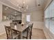 Elegant dining room with modern light fixture, wainscoting and an open view to the adjacent living space at 2895 Cross Creek Dr, Cumming, GA 30040
