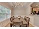 Elegant dining room with tray ceiling, pendant lighting, large windows, and wood floors, perfect for Gathering gatherings at 2895 Cross Creek Dr, Cumming, GA 30040