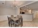 Bright dining area features a stylish chandelier and gray wood-look flooring that complements the open concept floor plan at 2895 Cross Creek Dr, Cumming, GA 30040