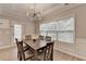 Inviting dining area with modern chandelier, wainscoting, and plenty of natural light from a large window at 2895 Cross Creek Dr, Cumming, GA 30040