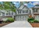 Charming townhouse with a brick-and-siding exterior, two-car garage and manicured landscaping at 2895 Cross Creek Dr, Cumming, GA 30040