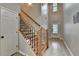 View of the home's foyer, showcasing a staircase with dark metal and wood trim, and a wooden floor at 2895 Cross Creek Dr, Cumming, GA 30040