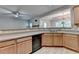Open kitchen layout with wood cabinets, stainless steel sink, and view to living area, ideal for modern living at 2895 Cross Creek Dr, Cumming, GA 30040