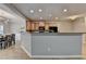 Modern kitchen with wooden cabinets, black appliances, and a breakfast bar at 2895 Cross Creek Dr, Cumming, GA 30040
