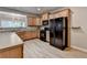 Well-lit kitchen featuring wood cabinets, black appliances, and durable countertops, offering both style and functionality at 2895 Cross Creek Dr, Cumming, GA 30040
