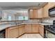 Updated kitchen with wood cabinets, stone backsplash, and stainless appliances, creating a functional and stylish cooking space at 2895 Cross Creek Dr, Cumming, GA 30040