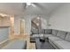 Open-concept living room with gray sectional sofa, wood floors, and staircase access at 2895 Cross Creek Dr, Cumming, GA 30040