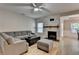Cozy living room featuring hardwood floors, a stone fireplace, and comfortable gray seating furniture at 2895 Cross Creek Dr, Cumming, GA 30040