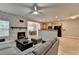 Open-concept living room with a stone fireplace, wood floors, and a view into the kitchen and dining area at 2895 Cross Creek Dr, Cumming, GA 30040