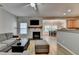 Cozy living room featuring hardwood floors, a stone fireplace, and a view to the kitchen and dining room at 2895 Cross Creek Dr, Cumming, GA 30040