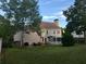 Expansive backyard featuring mature trees, a sunroom, and a patio with furniture at 323 Dewpoint Ct # 35, Marietta, GA 30064