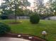 Nicely landscaped backyard with lush green grass and mature trees at 323 Dewpoint Ct # 35, Marietta, GA 30064
